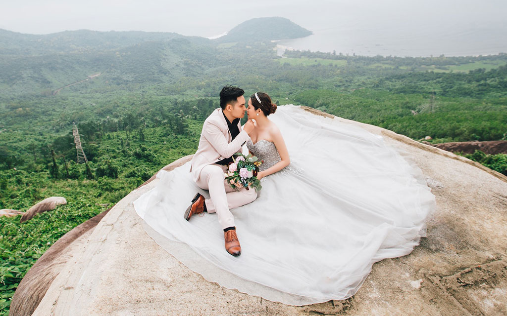 Bride and groom on a hilltop